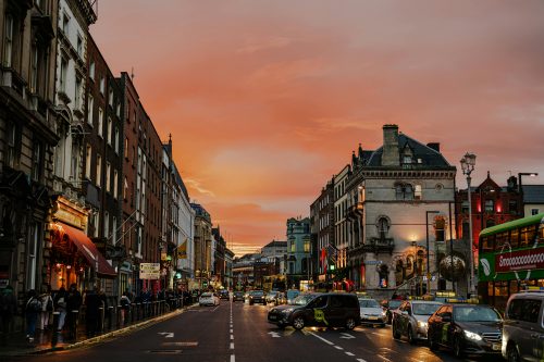 Dame Street in Dublin at sunset with evening traffic
