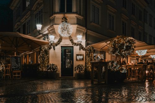 Ljubljana city street at night with lights and restaurants